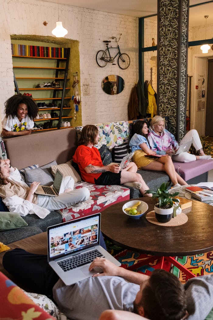 A diverse group of friends enjoying a cozy and casual hangout in a decorated living room.